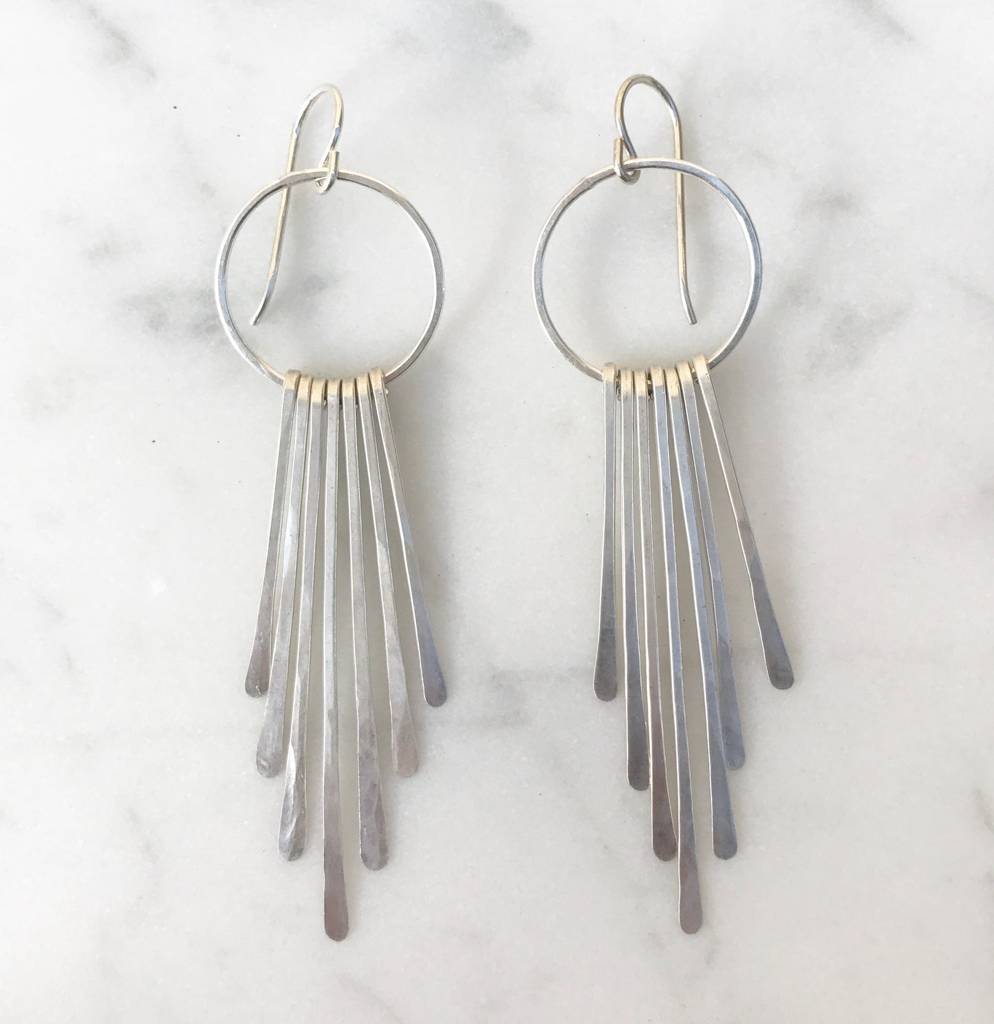 Long radiant ray fringe earrings