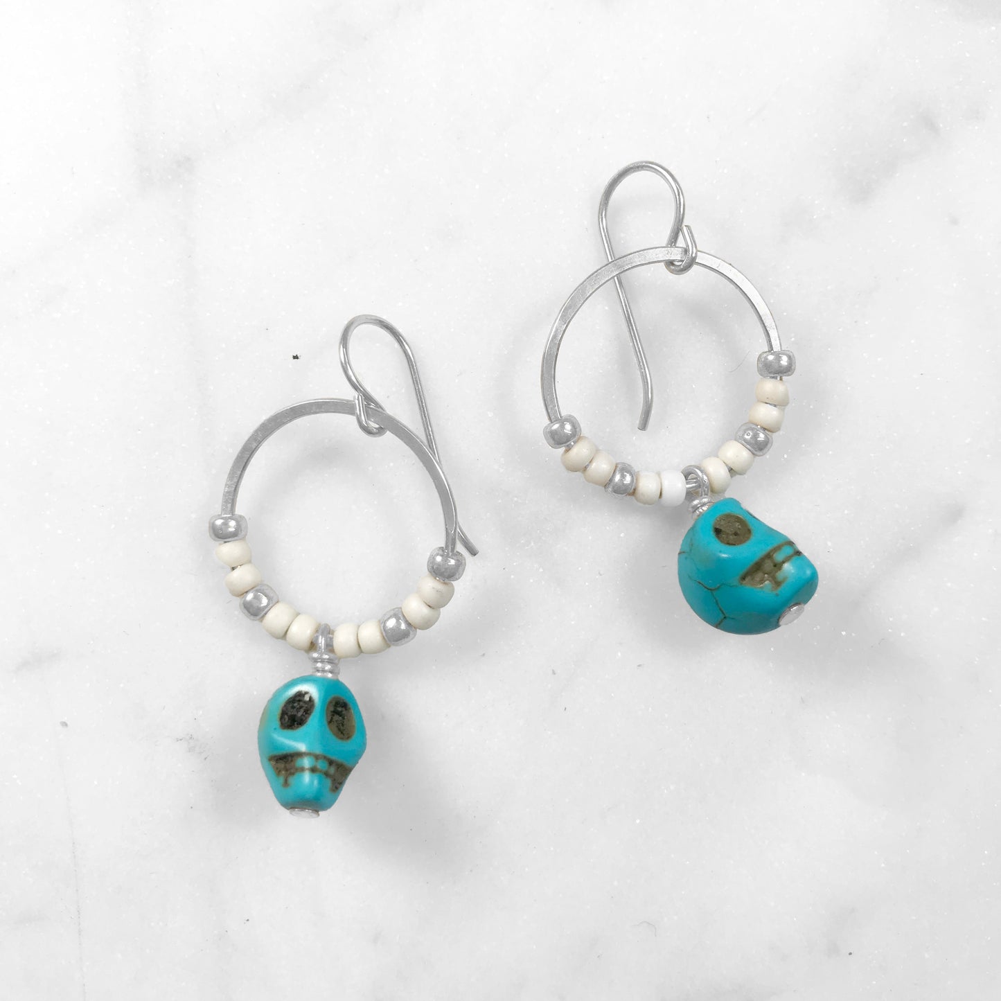 white & blue skull earrings