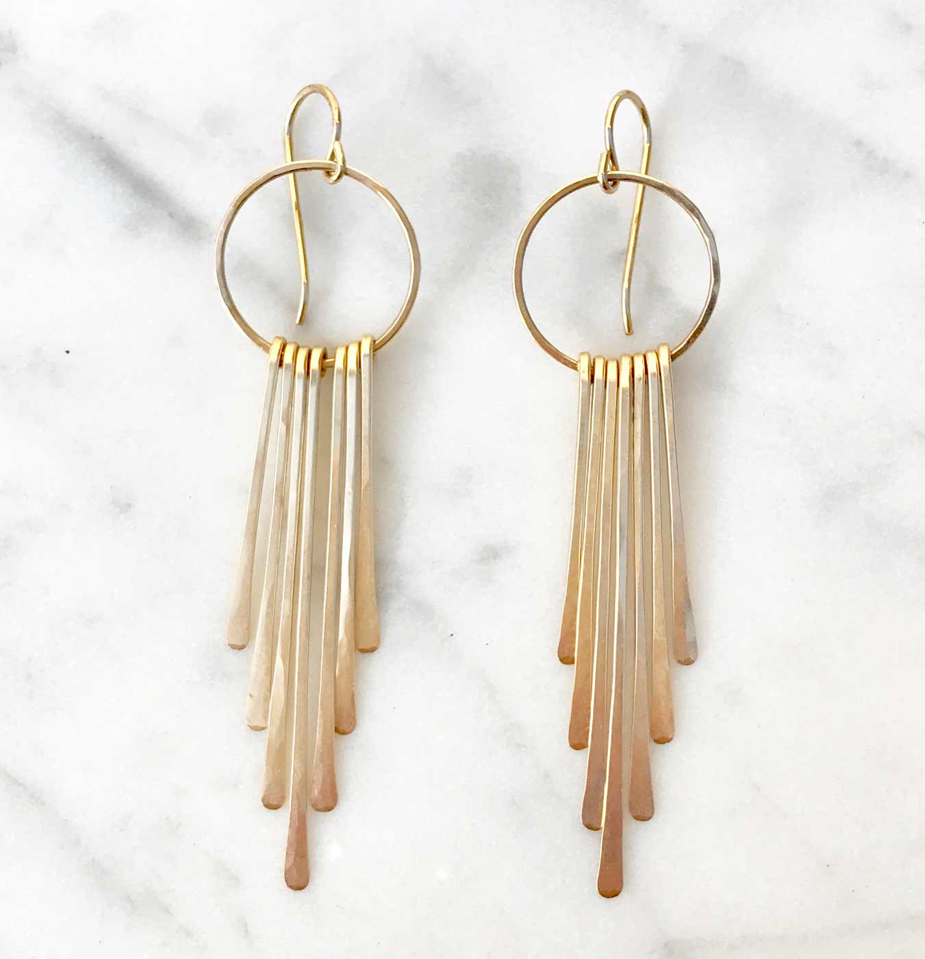Long radiant ray fringe earrings