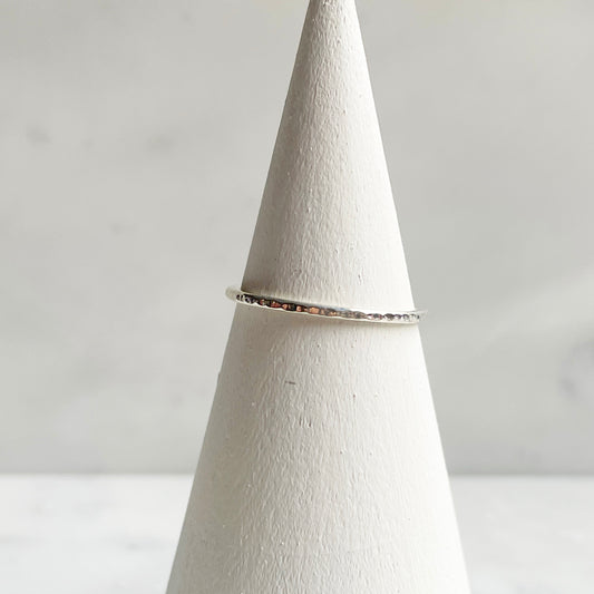 Extra Petite Line hammered band in silver on ring cone