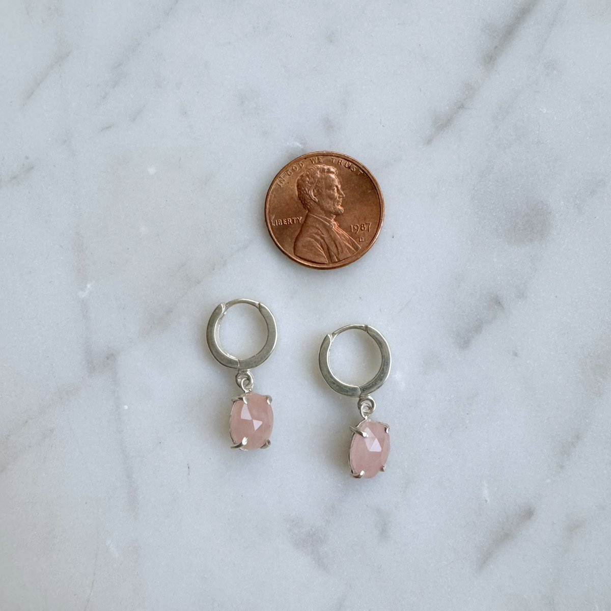 guava quartz huggie hoops in silver with penny for scale
